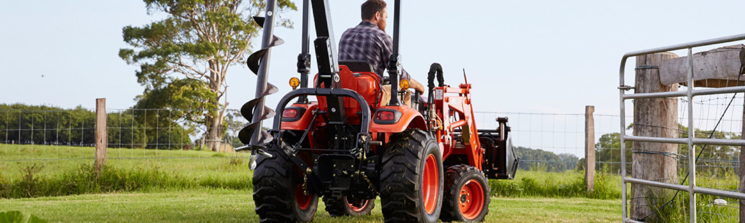 A man riding a 2020 KIOTI Loader to another side of the farm.