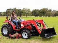 Woman riding a 2019 Mahindra 1526 4WD Shuttle on grass